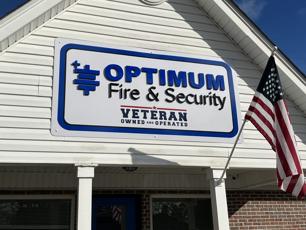 Custom building sign of Optimum Fire & Security business