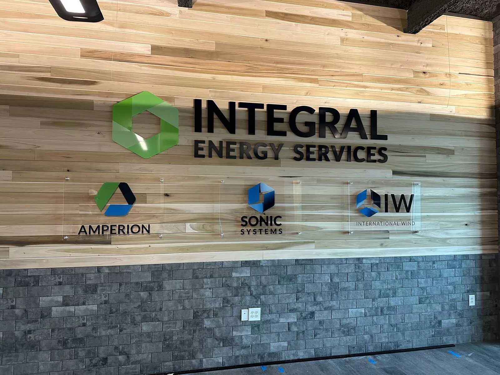 Vinyl Sign Of Integral Energy Services Installed On Glass